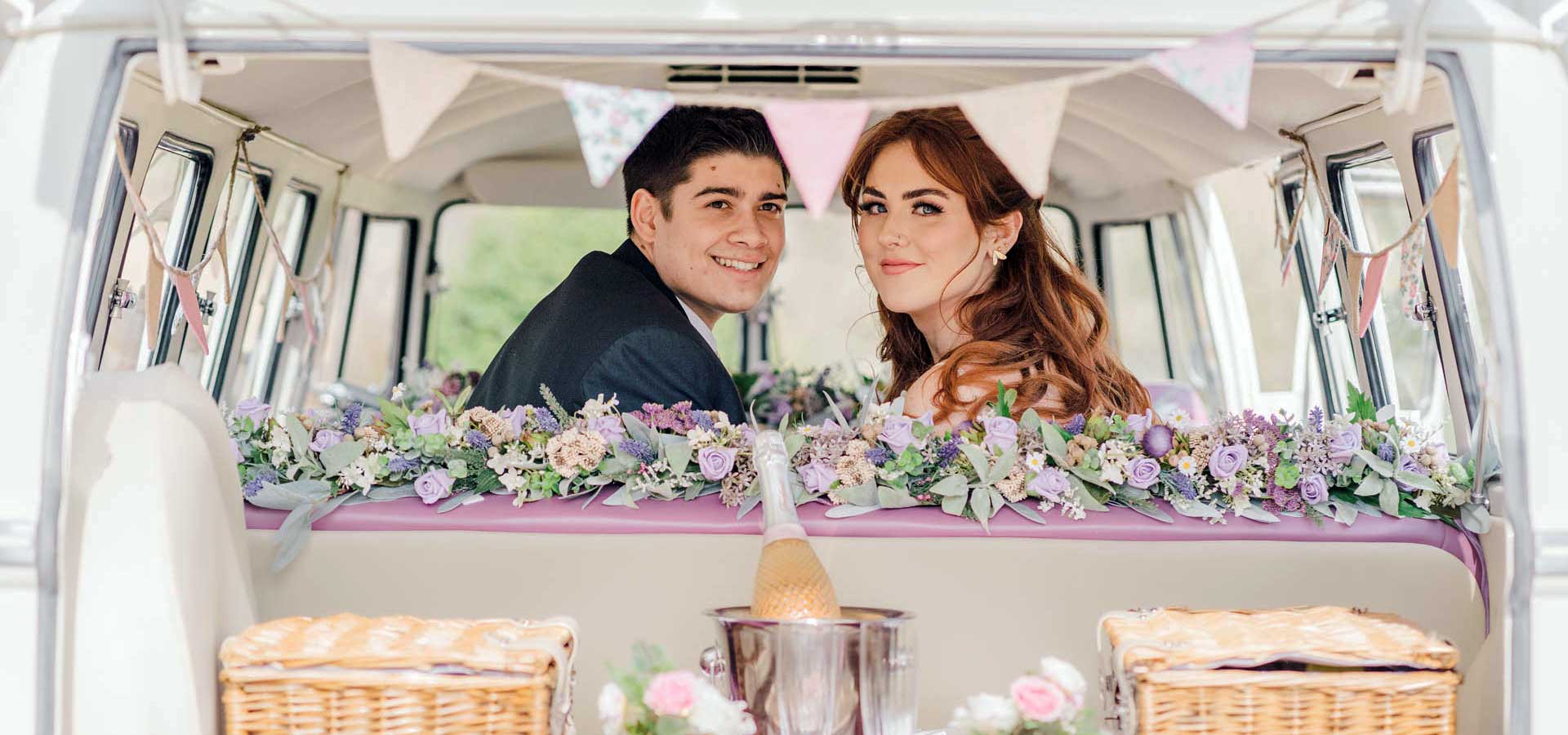 couple in the back of vintage wedding car